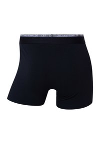 Boxers noirs pour hommes avec une ceinture de marque portant l'inscription « CRISTIANO RONALDO CR7 », montrés de dos sur un fond blanc.