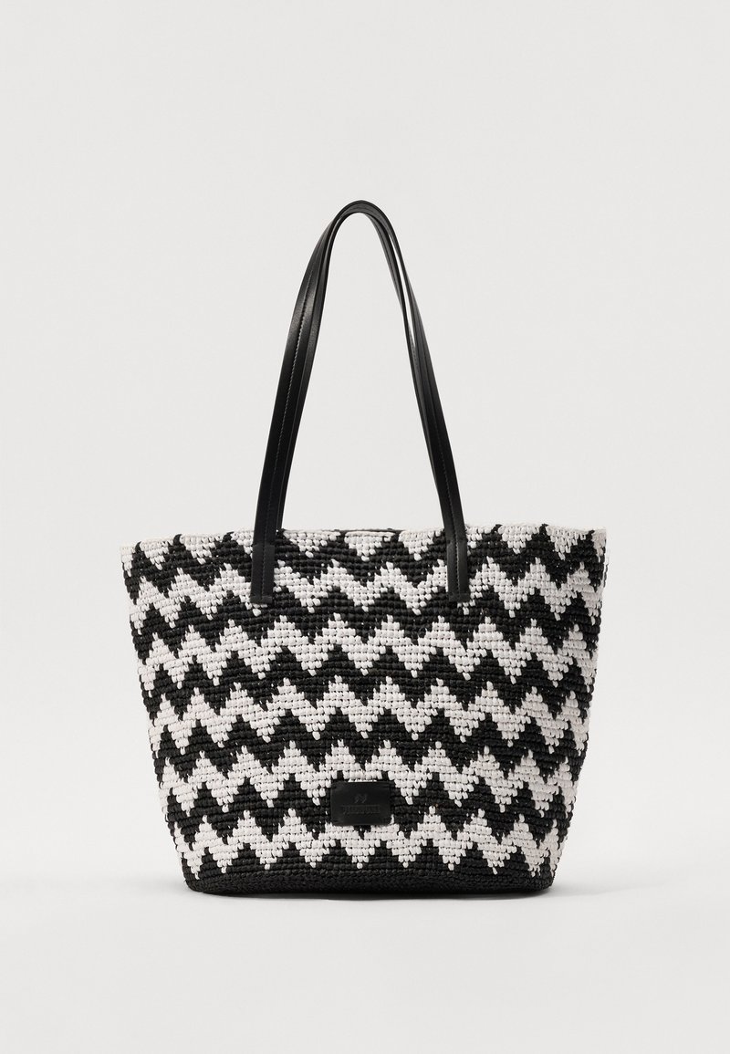 Aušanas iepirkumu soma ar melnbaltu zigzaga rakstu. Aprīkota ar divām melnas ādas rokturiem. Strukturēts materiāls ar izturīgu konstrukciju.