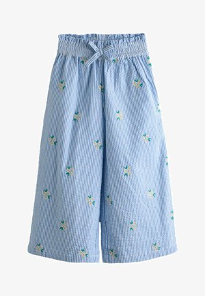 Pantalon large à rayures verticales bleu et blanc avec taille élastique, poches avant, nœud papillon et petite broderie florale jaune et blanche.