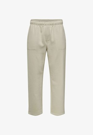 Pantaloni felpati beige in cotone con vita elastica, due tasche frontali e design a gamba dritta. Texture liscia con dettagli di cucitura minimali.