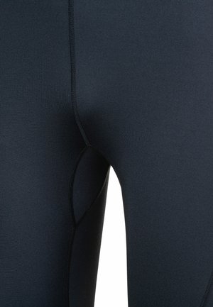 Leggings i mørk navy, lavet af strækbart stof. Har en søm, der skaber en åbning til en sidelomme og en glat finish uden synlige logoer.