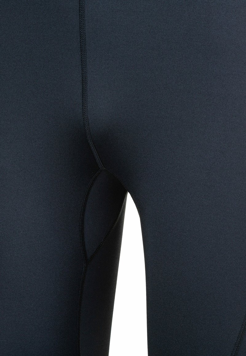 Leggings in donkermarineblauw, gemaakt van rekbaar materiaal. Heeft een naad die een opening voor een zijzak creëert en een gladde afwerking zonder zichtbare logo's.