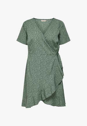 Green wrap dress with short sleeves, black polka dot pattern, ruffled hem, and tie closure at the waist. Smooth fabric texture.