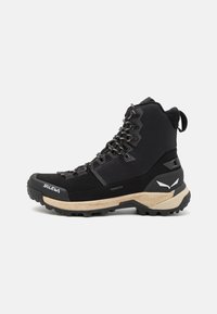 Black hiking boot featuring a waterproof Powertex upper, cushioned midsole, durable rubber outsole, and reinforced toe cap with metal lacing.