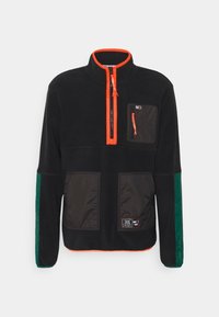 Black fleece pullover with orange zipper trim, chest pocket, two front pockets, and green sleeve panels, displayed on plain background.