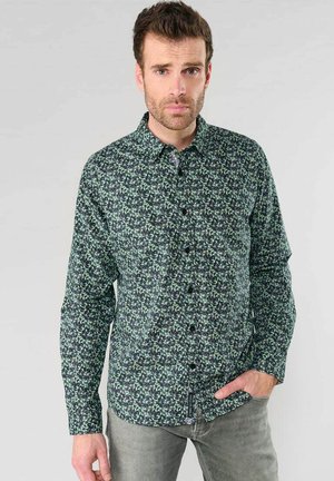 Long-sleeve shirt in dark green fabric with a floral pattern in light green, featuring a classic collar and button front.