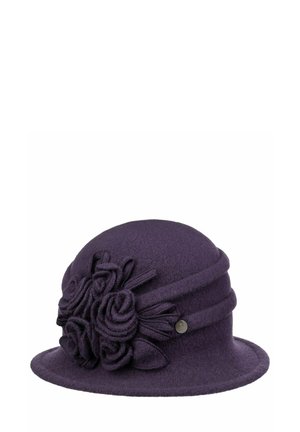 Purple felt cloche hat with rolled brim and floral fabric decorations on the side, featuring a small round metal brand emblem.
