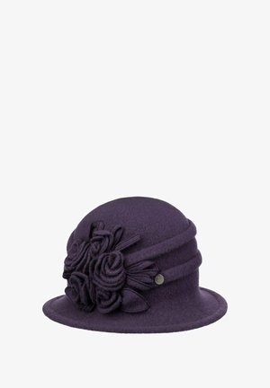 Purple felt cloche hat with rolled brim and floral fabric decorations on the side, featuring a small round metal brand emblem.