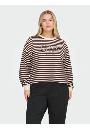 Svītrota brūnā un krēmkrāsas sporta krekls ar "BLISS" tekstu. Garas piedurknes, brīva piegriezuma un ribotas aproces. Zem tā melni bikses.