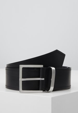 Black leather belt rolled with a silver rectangular metal buckle and matching metal belt loop on a white surface.