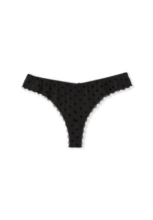 Schwarzer String aus durchsichtigem Stoff mit Polka-Dot-Muster. Verfügt über gerüschte Abschlüsse und Spitzenakzente sowie eine kleine Schleife vorne.