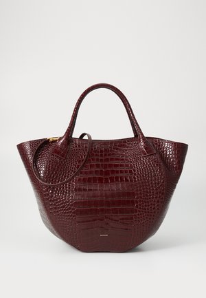 Maroon crocodile-embossed leather tote bag with two handles, a rounded shape, and a subtle gold-tone hardware accent.