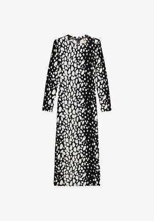 Langdouch jurk in zwart en wit met een gespikkeld patroon. Gemaakt van zachte stof, heeft een ronde hals en een rechte snit.