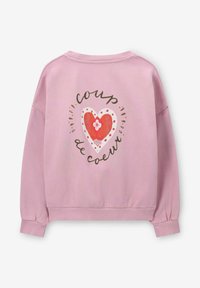 Sweat-shirt rose à manches longues. Présente un motif de cœur avec le texte "coup de coeur". Texture douce, poignets et ourlet côtelés.