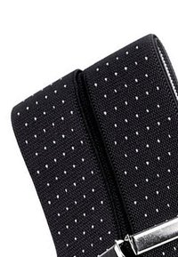 Black fabric wallet with white polka dots, zipper closure, and silver hardware accent. Textured surface for grip. Compact rectangular design.