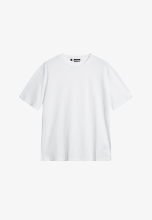 Valkoinen puuvillapaita, jossa on pyöreä kaula-aukko, lyhyet hihat ja hienovaraisesti kohokuvioitu logo rinnassa. Yksinkertainen, suora leikkaus.