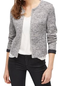 Chaqueta texturizada en gris y blanco con cuello redondo, apertura frontal y acentos negros en los puños. Presenta un diseño elegante y ajustado.