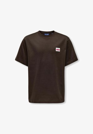T-shirt marron foncé à manches courtes et col rond avec un petit patch logo rectangle blanc et rouge sur le côté gauche de la poitrine.