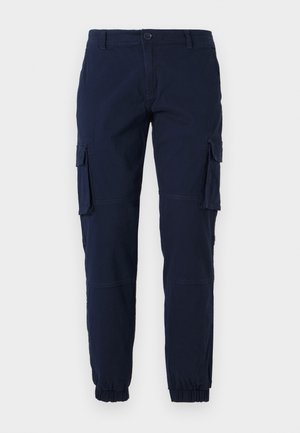 Navy cargo pants with elastic cuffs, multiple side pockets, and a zip-fly. Made from a durable fabric with smooth texture.