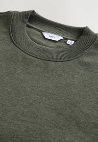 Olivgrön sweatshirt med rund halsringning och ribbad krage och ärmar. Tillverkad av mjukt material; har en liten lapp med "NEXT" på insidan.