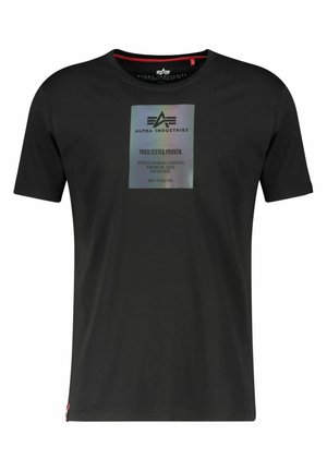 Black cotton T-shirt with crew neck, short sleeves, and a reflective graphic label detailing brand and testing claims on the front.