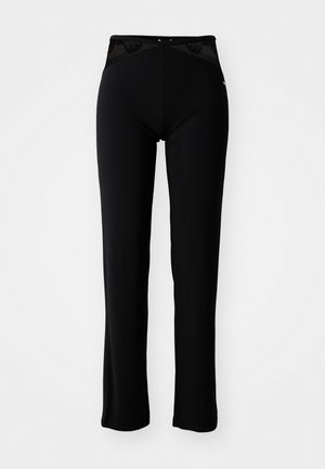 Zwarte legging gemaakt van rekbaar materiaal met een hoge tailleband die een kanten paneel bevat en een gladde afwerking heeft. Flared broekspijpen ontwerp.