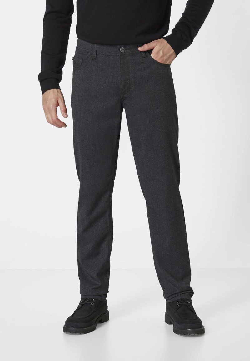Dark gray trousers made of textured fabric. They feature a straight-leg cut, front pockets, and a button closure. Worn with black boots.