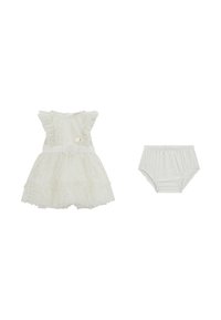Hvid kjole med flæser på ærmerne, guld prik-mønstre og en hjerteknap, parret med matchende hvide bloomers. Blødt stof og lagdelt nederdel.