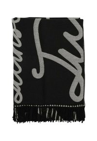 Coperta tessuta in nero e grigio con dettagli a frange, caratterizzata da un design astratto audace in un colore più chiaro su uno sfondo scuro.