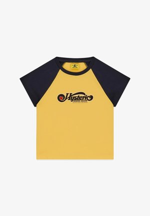 Yellow short-sleeve shirt with black raglan sleeves, "Hysteric Guess Jeans" logo and red heart design on the chest.