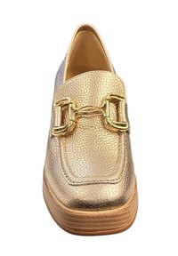 Mocassin en cuir doré avec une finition texturée, présentant un grand accent de chaîne dorée sur le dessus et un talon en bois empilé.