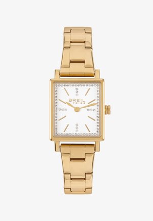 Montre rectangulaire en or avec un cadran blanc, accents en cristal autour de la lunette et bracelet en maillons métalliques dorés. Marqueurs d'heure simples.