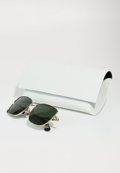 Ochelari de soare cu lentile verzi, cadru din metal auriu și vârfuri negre, alături de un toc din piele albă gravat cu "Burberry".