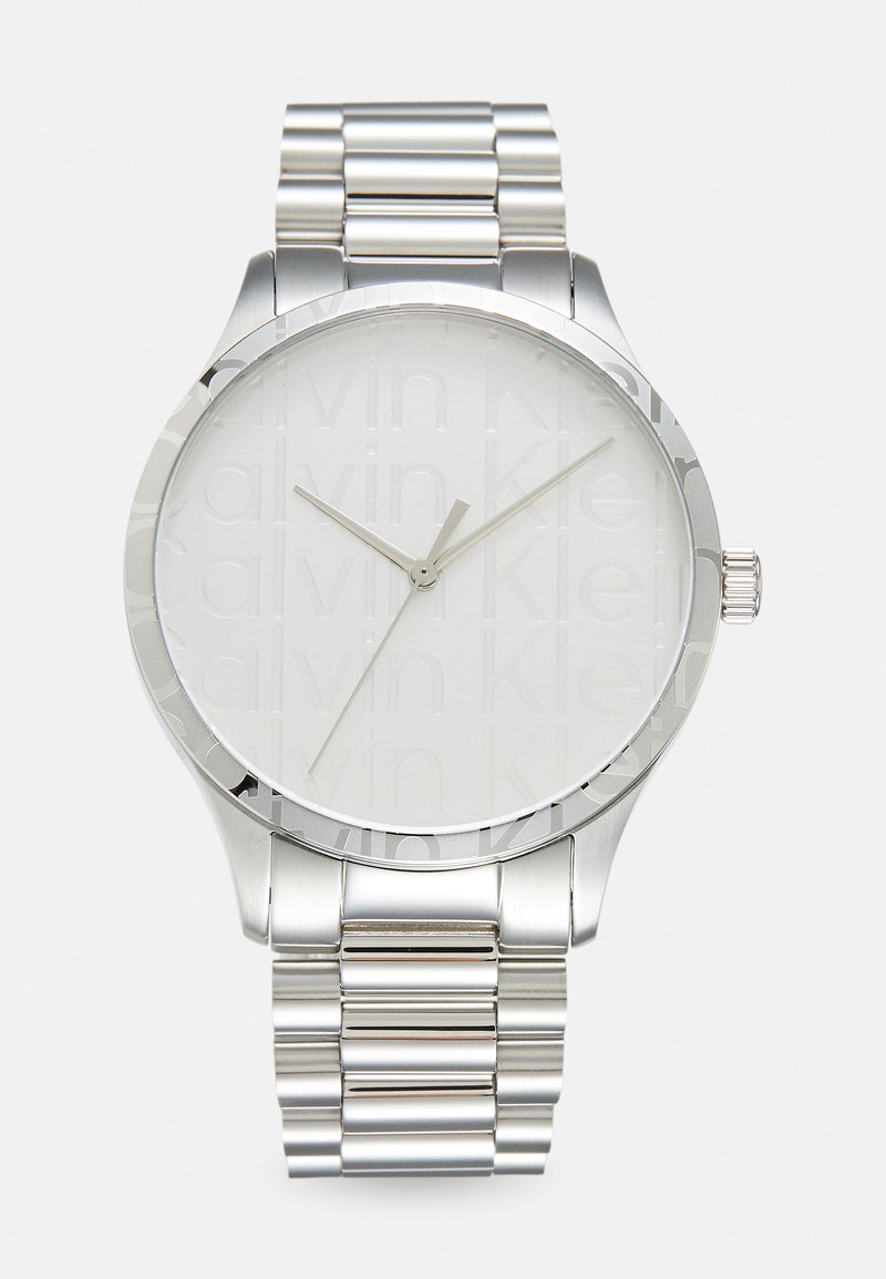 Silver stainless steel watch with a round face, showcasing an embossed logo, minimalist design, and a link bracelet.
