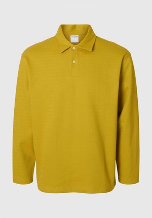Long-sleeve polo shirt in mustard yellow with a textured, ribbed pattern. Features a classic collar and two-button placket.