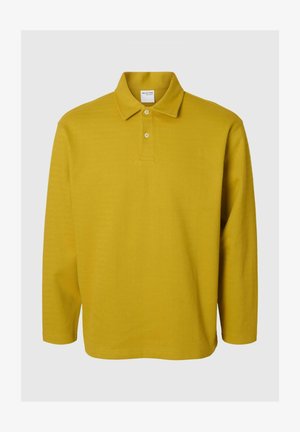 Koszulka polo z długim rękawem w musztardowym kolorze z teksturowanym, prążkowanym wzorem. Posiada klasyczny kołnierzyk i zapięcie na dwa guziki.