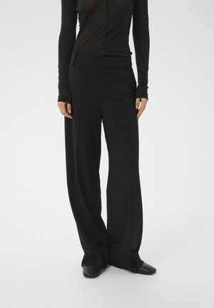 - Spodnie materiałowe