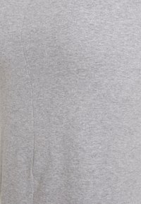 T-shirt de algodão cinza com textura canelada e formato ajustado, sem logótipos ou padrões visíveis. Acabamento suave e tecido macio.