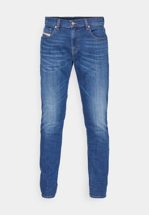 Blue denim jeans with a straight leg design, light wash finish, five-pocket style, button closure, and orange stitching accents.
