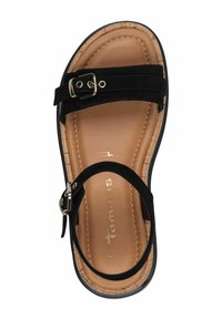 Black suede sandal with a buckle, contoured beige insole, and cork-like texture on the outsole. Flat design, open-toe style.