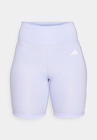 Lilla sykkelshorts laget av glatt, elastisk stoff. Høy midje med flate sømmer og en hvit Adidas-logo på venstre side.