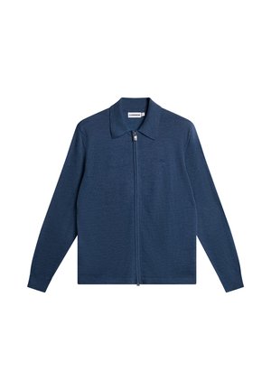 Mørkeblå zip-up jakke med flad krave, lange ærmer og et tekstureret strikket stof. Har et lille logo på brystet.