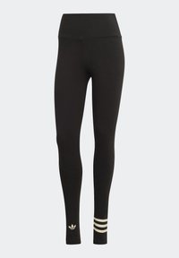 Mustat leggingsit, jotka on valmistettu joustavasta kankaasta ja joissa on korkea vyötärö. Ominaisuuksiin kuuluu kultainen logo ja kolme valkoista raitaa nilkassa.