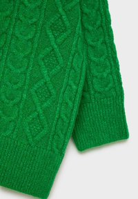 Pull vert en tricot avec un motif torsadé texturé, présentant des poignets côtelés contrastants et un matériau doux semblable à de la laine.