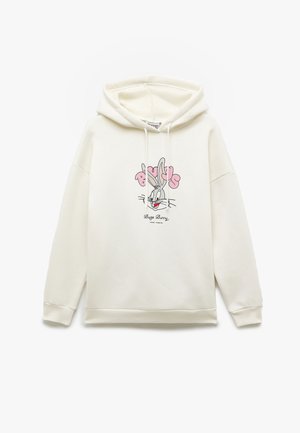 Biała bluza z kapturem ze sznurkiem i ściągaczami. Na przodzie znajduje się kolorowa grafika Bugs Bunny. Prosty krój, miękka tekstura materiału.