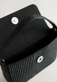 Black handbag with textured studded exterior, open flap showing black fabric interior and silver magnetic clasp closure.