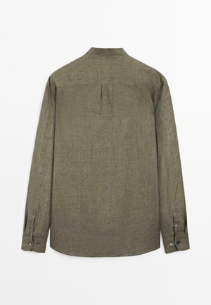 Khaki green long-sleeve shirt displayed from the back, featuring a small collar and buttoned cuffs. Textured fabric visible.