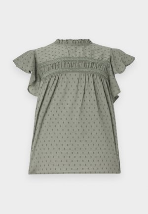 Vestido verde com mangas curtas e franzidas, tecido texturizado com padrão de bolinhas, detalhes franzidos no peito e um decote alto.