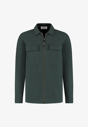 Grüne Zip-Up-Bluse aus strukturiertem Stoff. Verfügt über einen Kragen, zwei Brusttaschen und lange Ärmel mit knöpfbaren Manschetten.