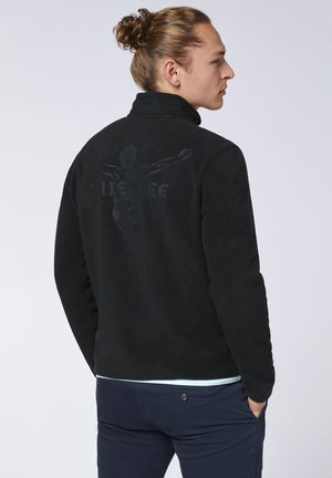 Black fleece jacket with a high collar and a subtle graphic design on the back. Soft texture, classic fit, and lightweight material.